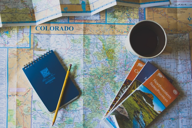 Books and pencil on map